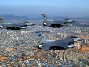 F 16 Fighting Falcons Over City